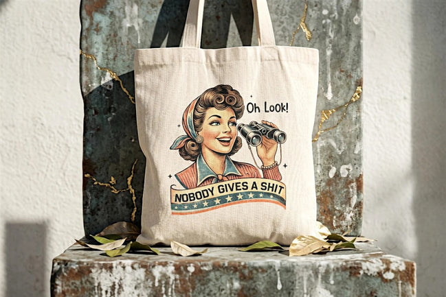 Tote bag en toile beige Roaring 20s Paris avec illustration vintage d'une femme regardant dans des jumelles et le texte "Nobody Gives a Shit – Oh Look!".